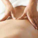 therapist applying massage techniques to a woman's back