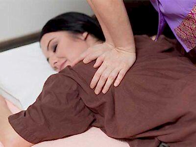 therapist applying Thai massage techniques to a woman's shoulders